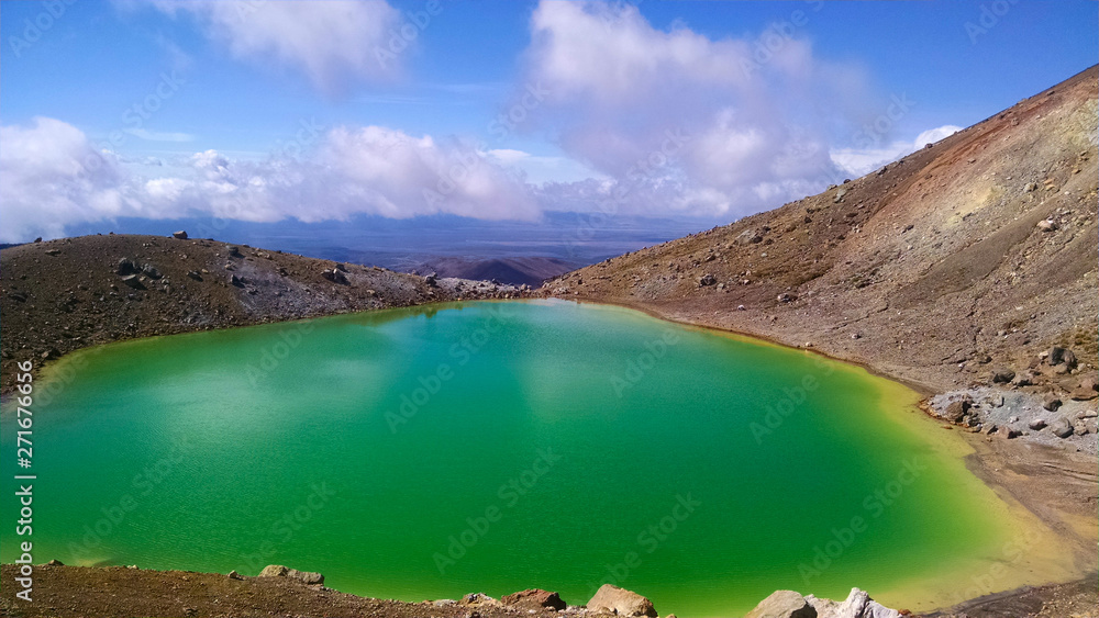 Green Lake on the side of a Mountain with Beautiful Sky in New Zealand