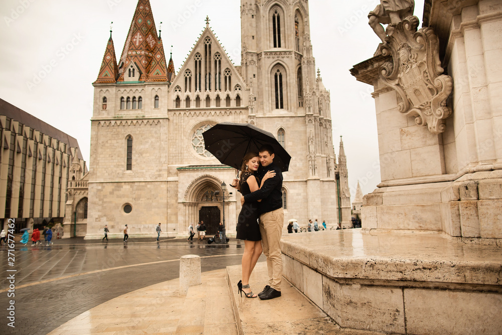 Young beautiful stylish pair of newlyweds walking by the Fisherman's Bastion in Budapest, Hungary