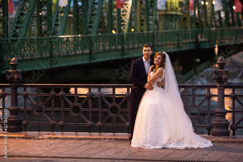 Young beautiful stylish pair of newlyweds near the river in Budapest