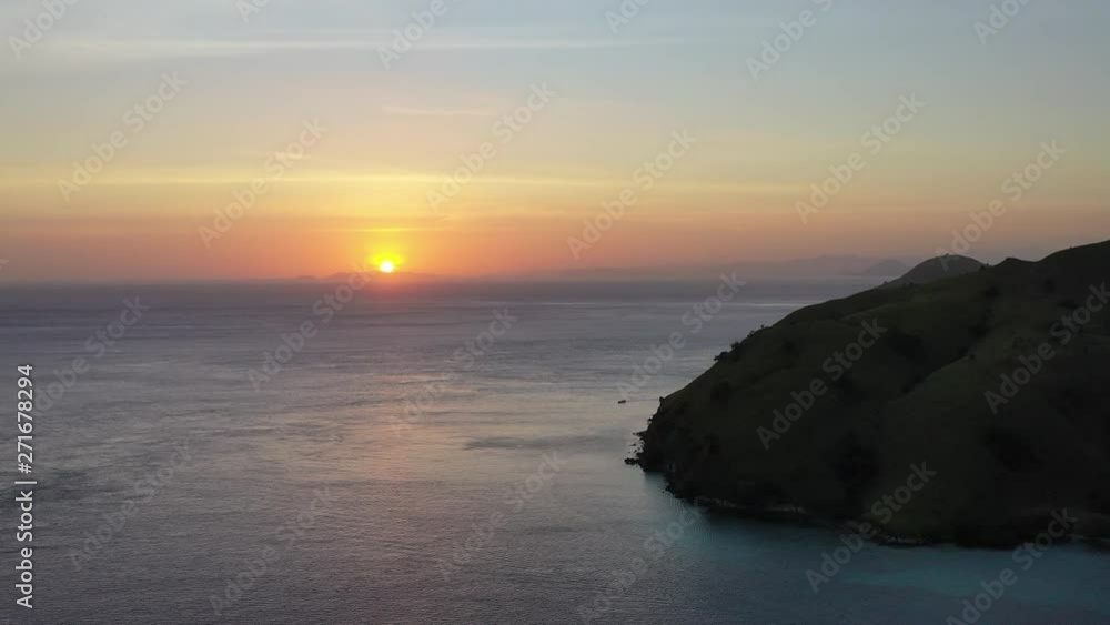 The sun begins to rise, illuminating islands within Komodo National Park, Indonesia. This tropical area is known for both its marine biodiversity as well as its infamous dragons. The sun begins to rise, illuminating islands within Komodo National Park, Indonesia. This tropical area is known for both its marine biodiversity as well as its infamous dragons.