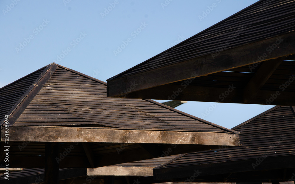Wooden umbrellas on the beach.