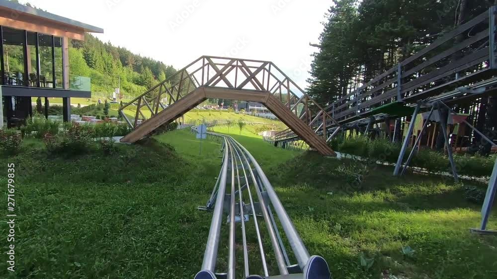 The fast riding of a mountain coaster from the first person. Spring, sunny weather. The fast riding of a mountain coaster from the first person. Spring, sunny weather.