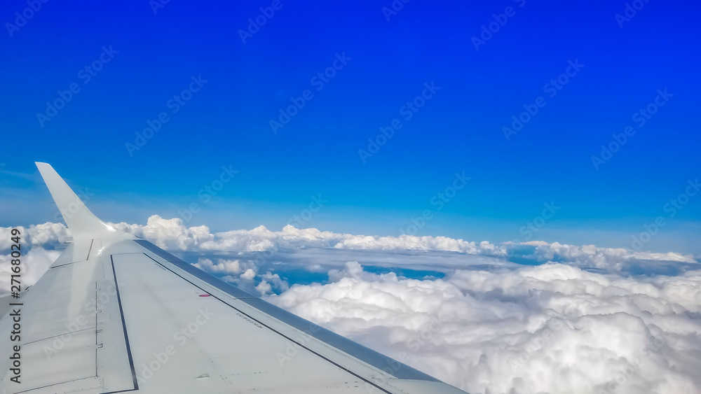 Looking out through an airplanes porthole window during a flight. Looking out through an airplanes porthole window during a flight.