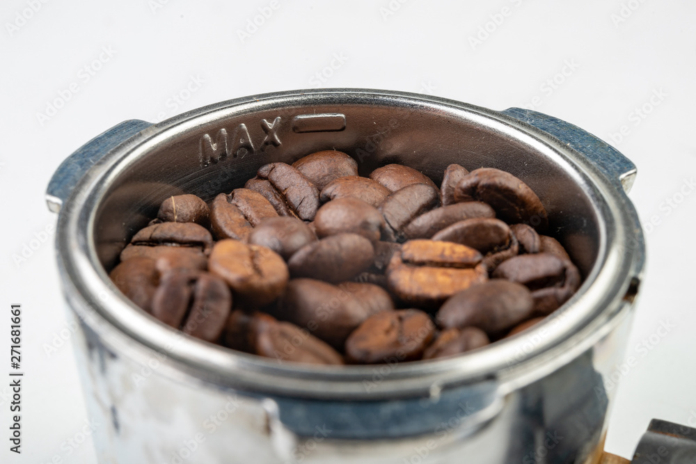 Fototapeta premium Black roasted coffee beans and a coffee machine flask. Coffee making accessories.