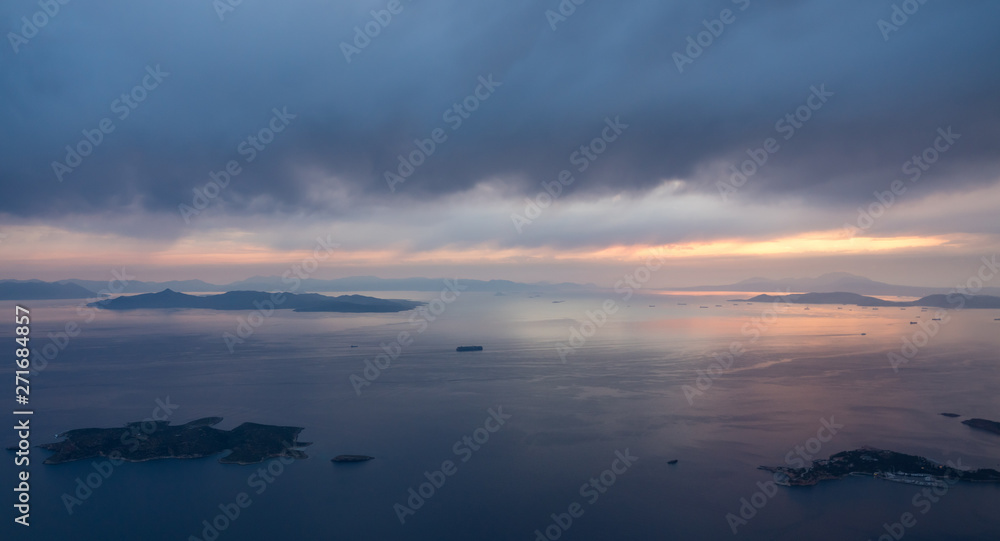 View of coastline and islands near Athens airport as plane descends at sunset