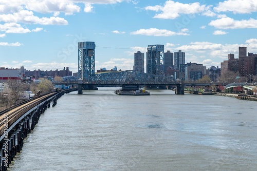 Looking southward along the Harlem River at the Madison Avenue Bridge in Harlem, NYC, USA