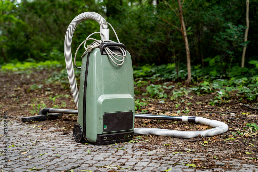 Old vacuum cleaner in outdoor environment Stock Photo