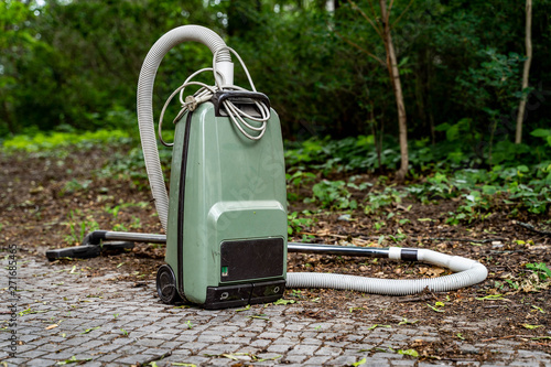 Old vacuum cleaner in outdoor environment