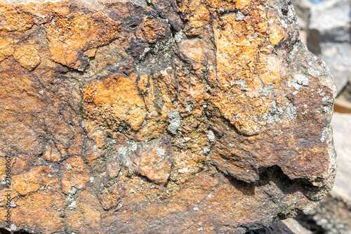 Closeup of a rock texture  with small patches of Lichen on the surface