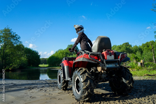 Outdoor activity. Quad bike rides. Extreme sport. Nature, forest, river.