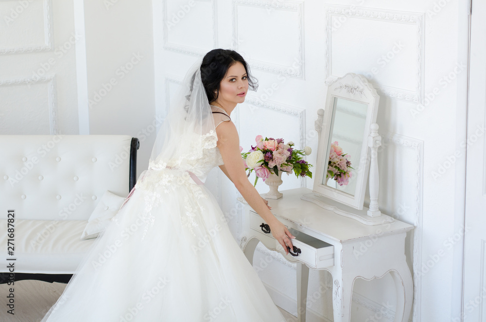 bride in white wedding dress in living room