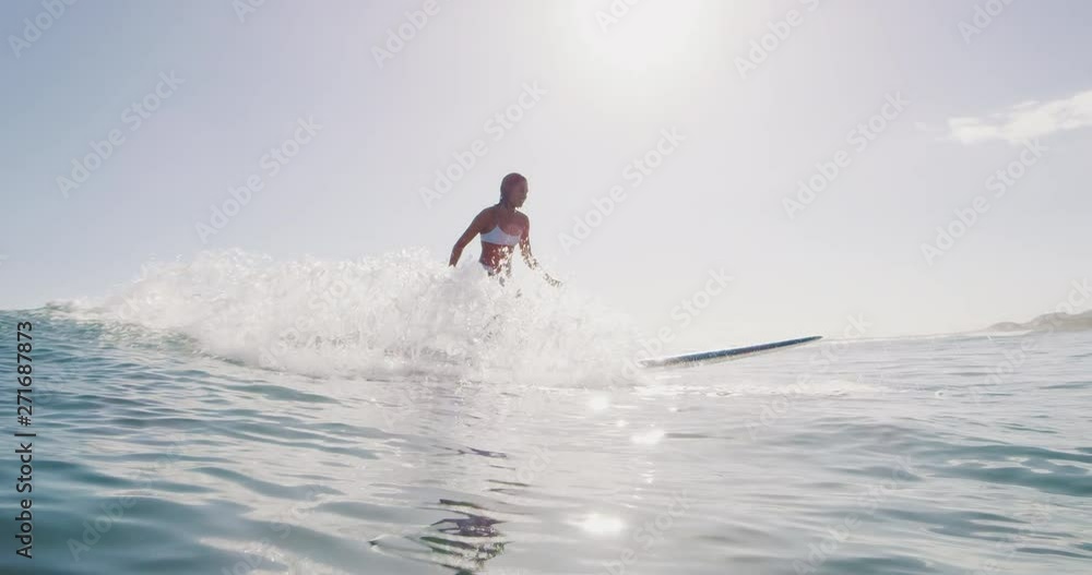 Young woman surfing in slow motion on summer wave, doing amazing longboard turn in, summer surf vacation Young woman surfing in slow motion on summer wave, doing amazing longboard turn in, summer surf vacation