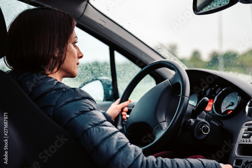 Woman driving car on the motorway in the rain © kerkezz