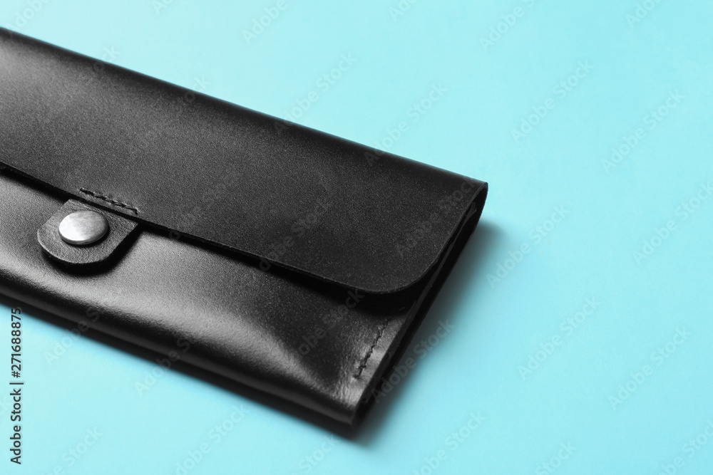 Leather wallet on color background, closeup with space for text. Stylish accessory Leather wallet on color background, closeup with space for text. Stylish accessory