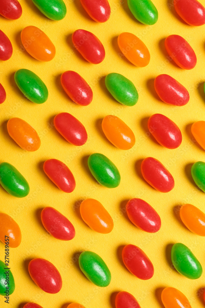 Flat lay composition with delicious jelly beans on color background Flat lay composition with delicious jelly beans on color background