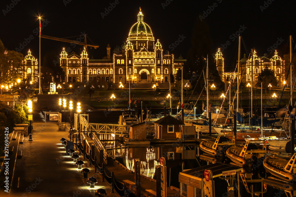 A night time view of the parliament building and harbor of Victoria, British Columbia, Canada.