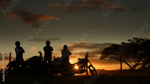 motorcyclists enjoy the sky in late afternoon