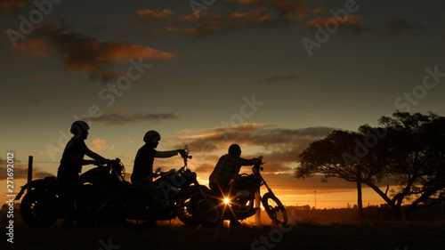  motorcyclists enjoy the sky in late afternoon