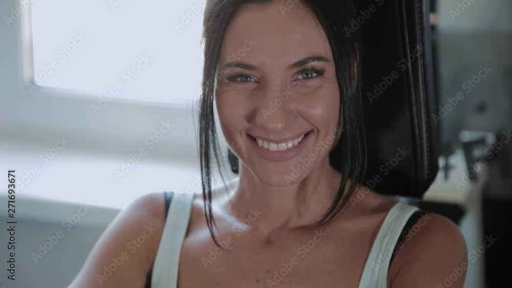 Athletic beautiful woman performs on the simulator leg extension. Athletic beautiful woman performs on the simulator leg extension.