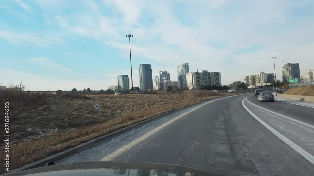 Driving On Freeway With Buildings On Either Side And Traffic Driving On Freeway With Buildings On Either Side And Traffic