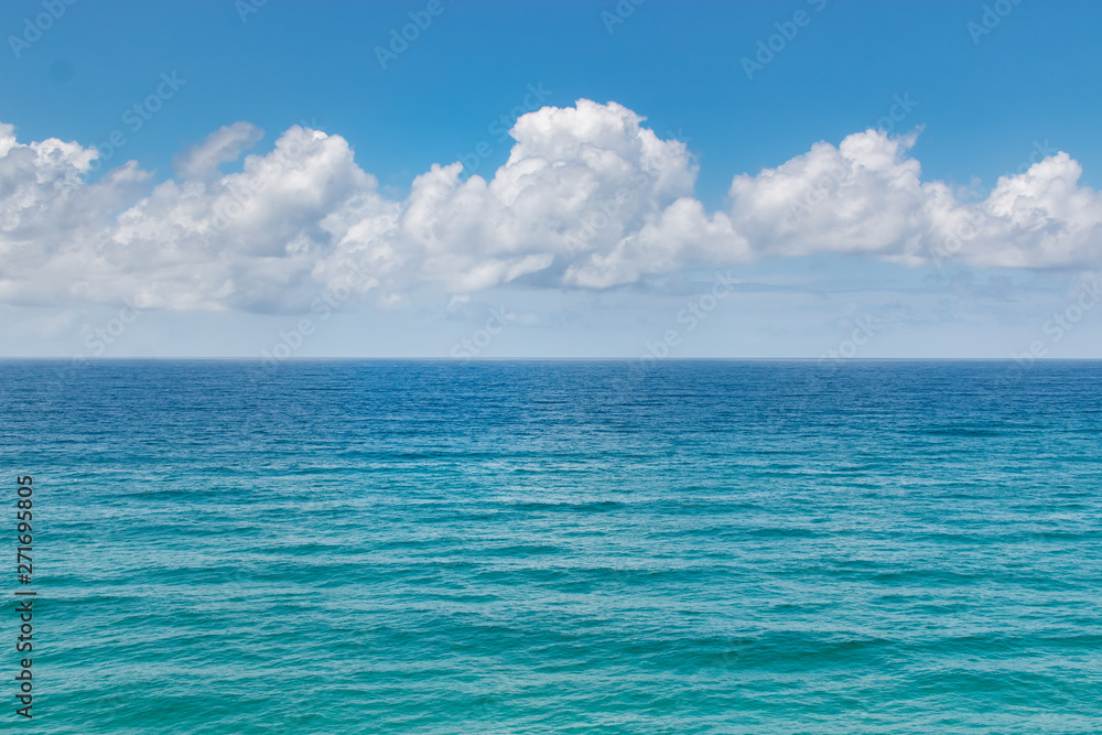 tropical ocean sea water and fluffy clouds landscape 