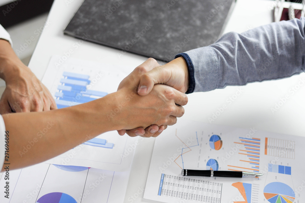 Close-up of business partners shaking hands and.hand business men and women who shaking hands Close-up of business partners shaking hands and.hand business men and women who shaking hands