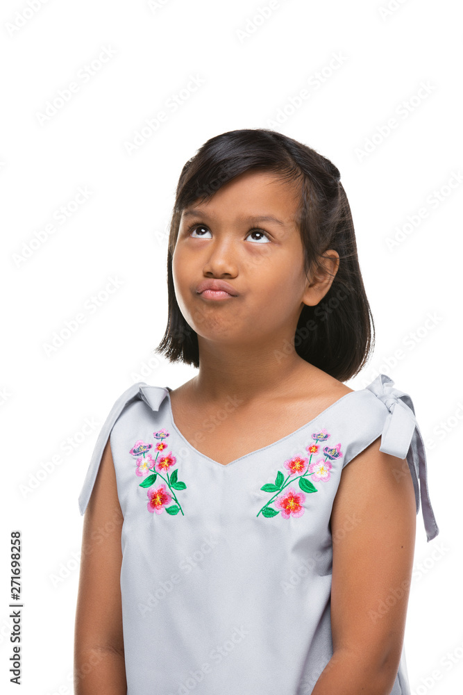 Cute asian dark little girl making a funny emotion on face . Cute asian dark little girl making a funny emotion on face .