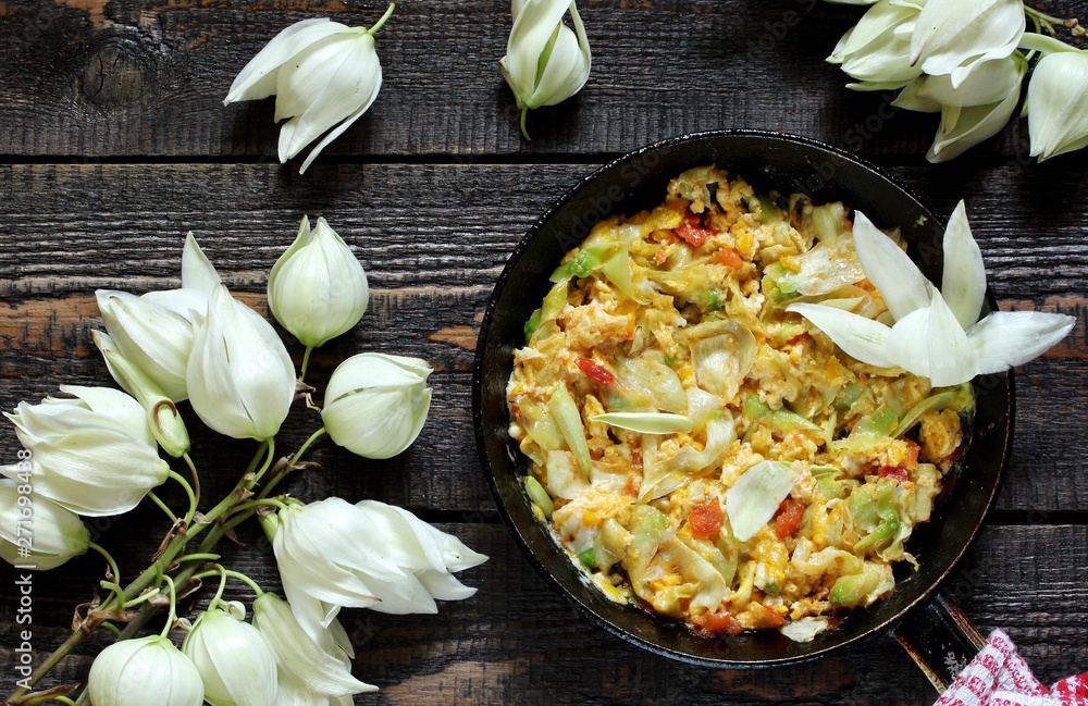 Yucca flowers dish. flower petals fried with eggs and tomatoes