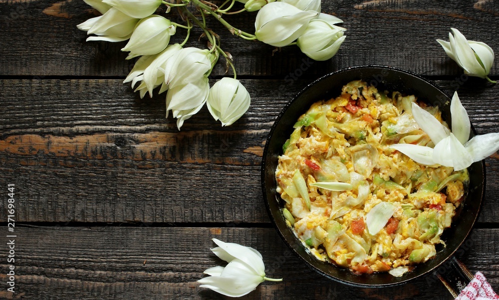 Yucca flowers dish. flower petals fried with eggs and tomatoes