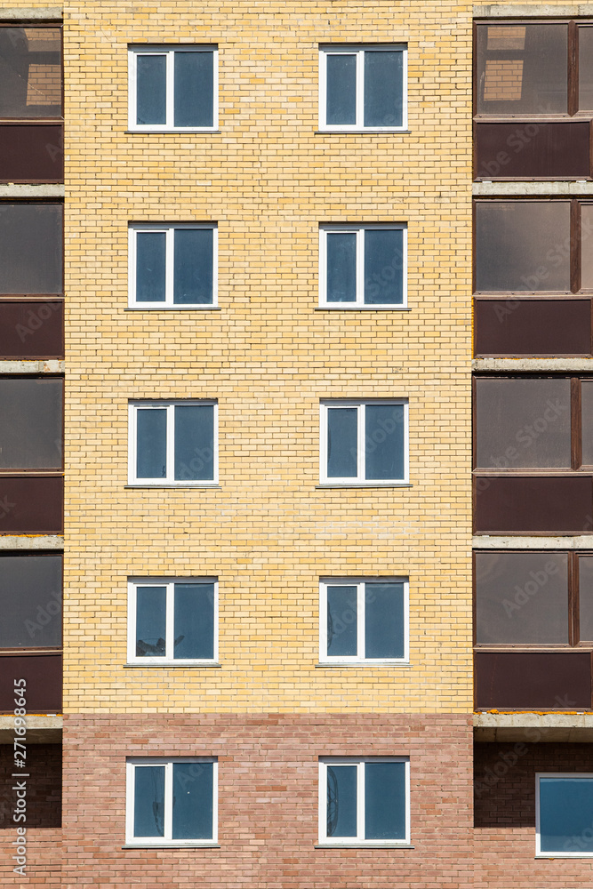 High-rise red brick house with windows, architecture.