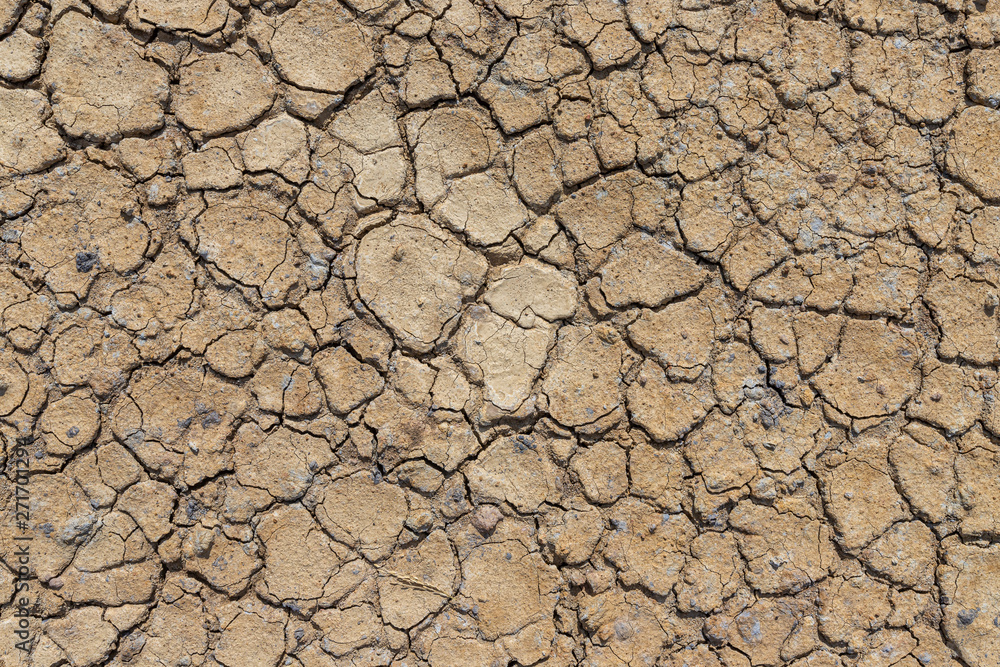 Brown dry soil or cracked ground texture background. Brown dry soil or cracked ground texture background.