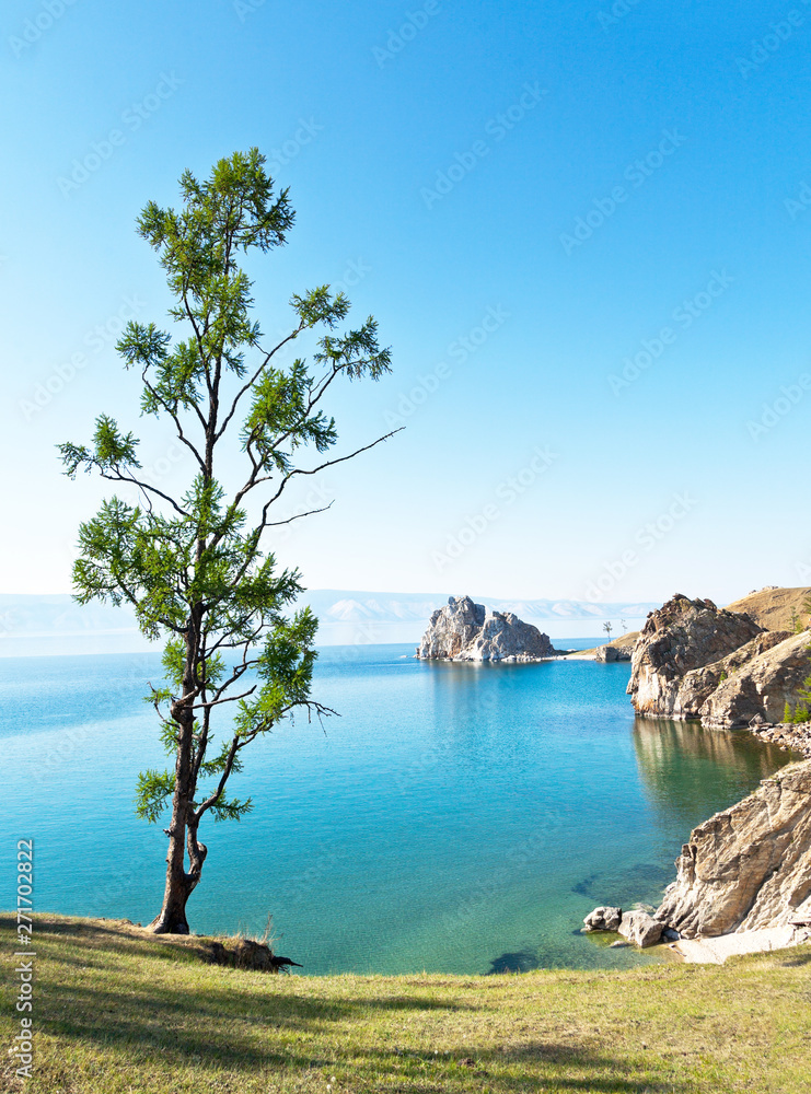 Obraz premium Baikal Lake summer afternoon. View of the natural attraction of Olkhon Island - Shamanka Rock and Burhan Cape. Lake natural background. Beautiful landscape