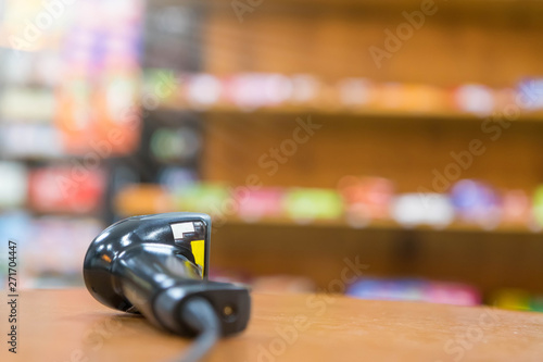 Close up barcode scanner in hand on blurred background,Inspection of goods in the warehouse,The concept of selling products in a supermarket,Spot focus,Copy space. © KM.Photo