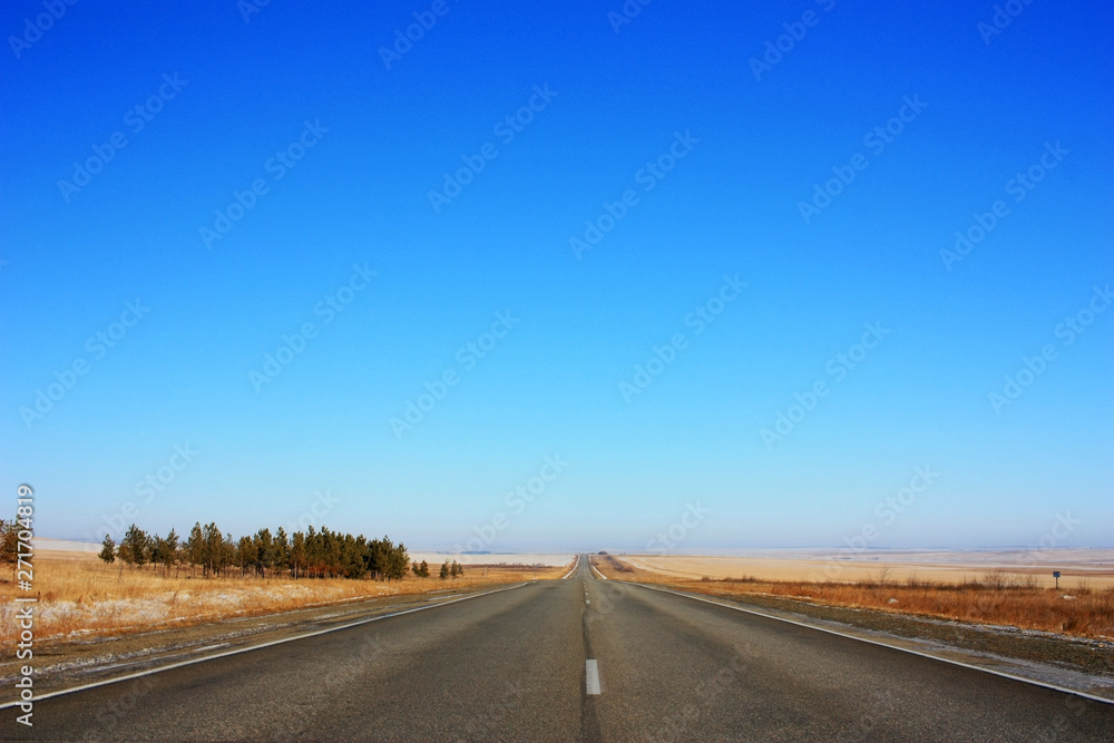Empty asphalt road in the field