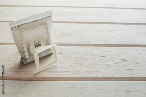 carry coffee drip bag on white wood table