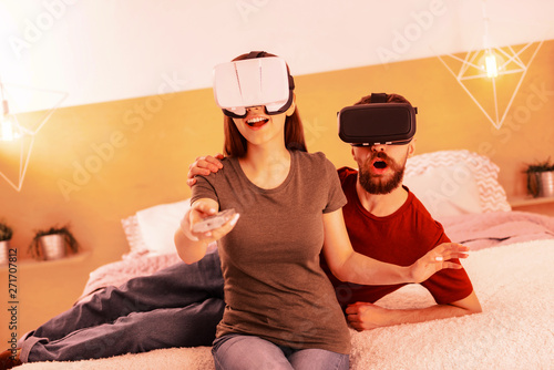 Sweet couple playing virtual reality at home