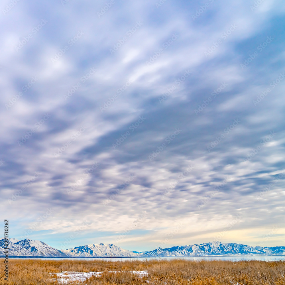 Frame Square Panorama of a frosty mountain and lake under a stunning sky filled with clouds Frame Square Panorama of a frosty mountain and lake under a stunning sky filled with clouds