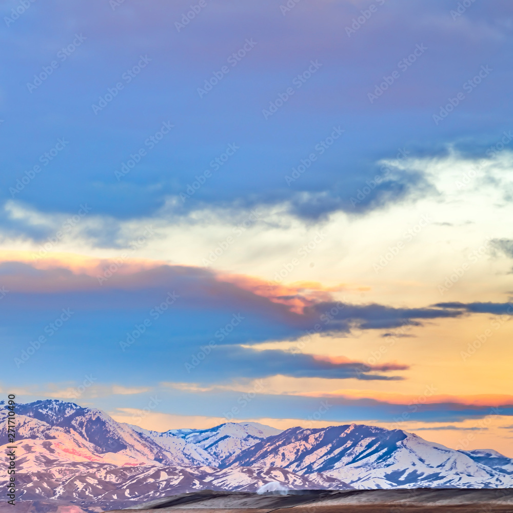 Frame Square Panorama of a magnificent snow covered mountain beyond a lake at sunset