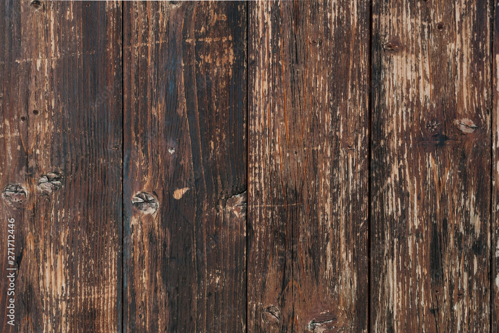 Brown scratched wooden cutting board. Wood texture. Brown barn wooden boards panel for modern vintage home design textured background Brown scratched wooden cutting board. Wood texture. Brown barn wooden boards panel for modern vintage home design textured background