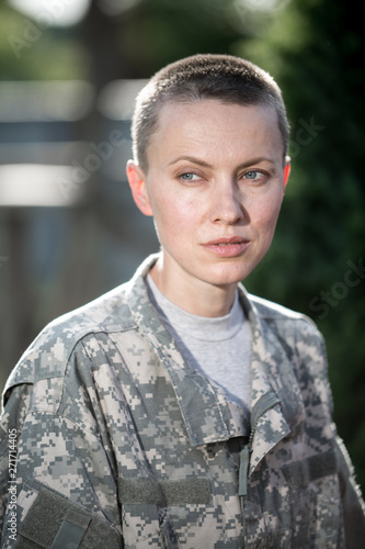 Beautiful american soldier in uniform on natural green background