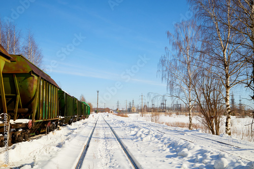 Train cars on rails in winter day on snow