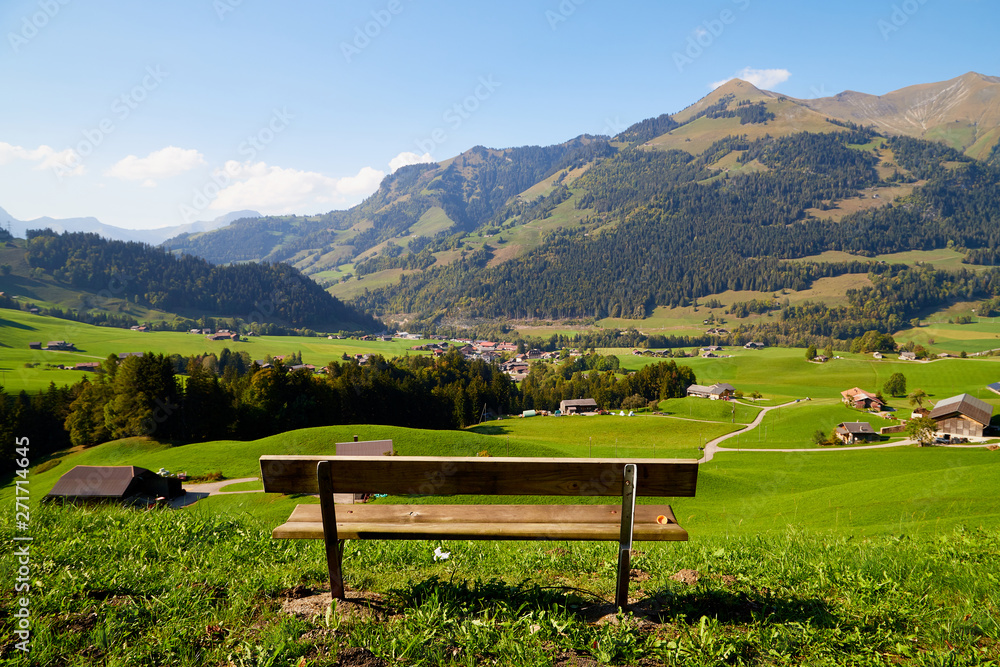 Mountain valley with green grass and village below. View from height Mountain valley with green grass and village below. View from height