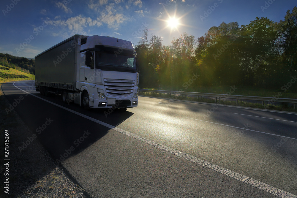 Truck transport on the road at sunset and cargo