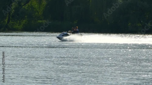 Waterboat sailing along the river. Entertainment and recreation on the water on a jet ski. Camping with family. photo
