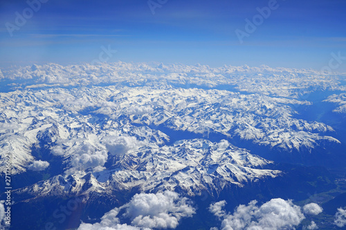 Aerial view of the Alps Mountains covered with snow over France and Switzerland © eqroy