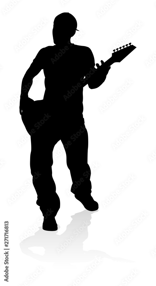 A guitarist musician in detailed silhouette playing his guitar musical instrument. A guitarist musician in detailed silhouette playing his guitar musical instrument.