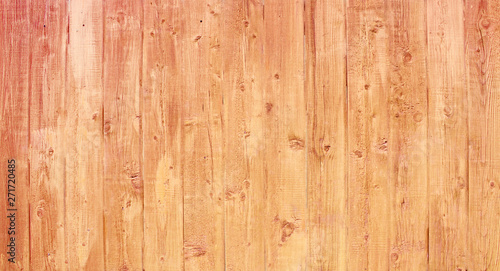 Natural wooden background. Surface of wooden texture for design and decoration. Shabby vertical boards with peeling paint. Brown with a pink shade. Copy space.