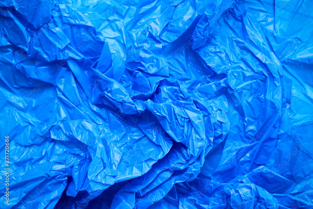 Fototapeta premium Blue crumpled plastic bag texture background. Waste recycle concept. Polyethylene clear garbage bags. 