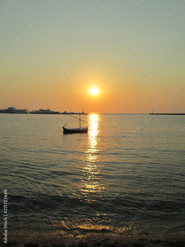 small boat at the sunset