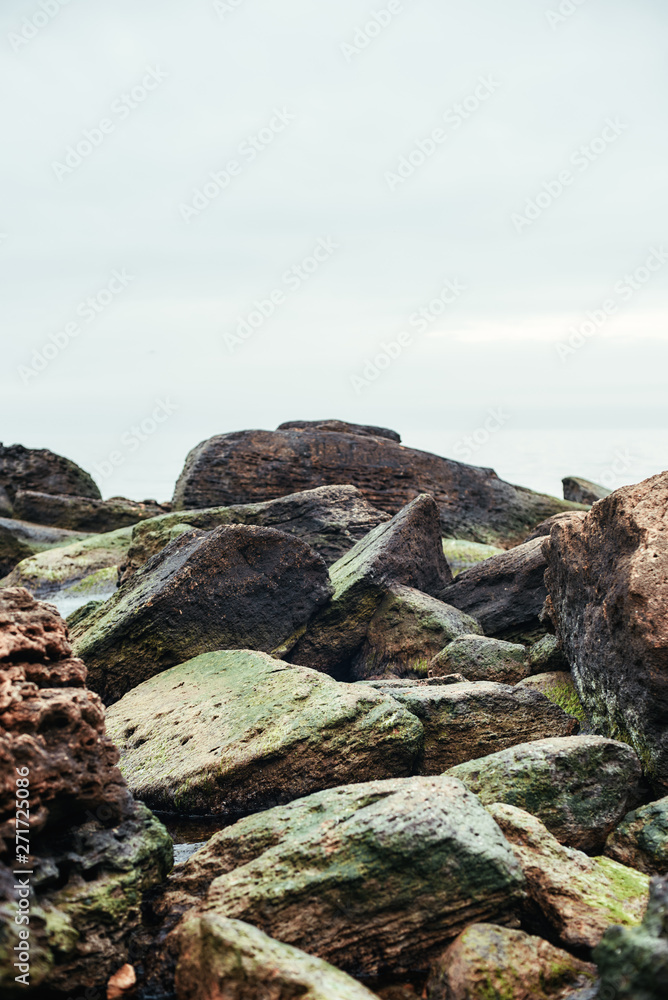Vertical close up photo of big boulders on the beach. Nature landscape.